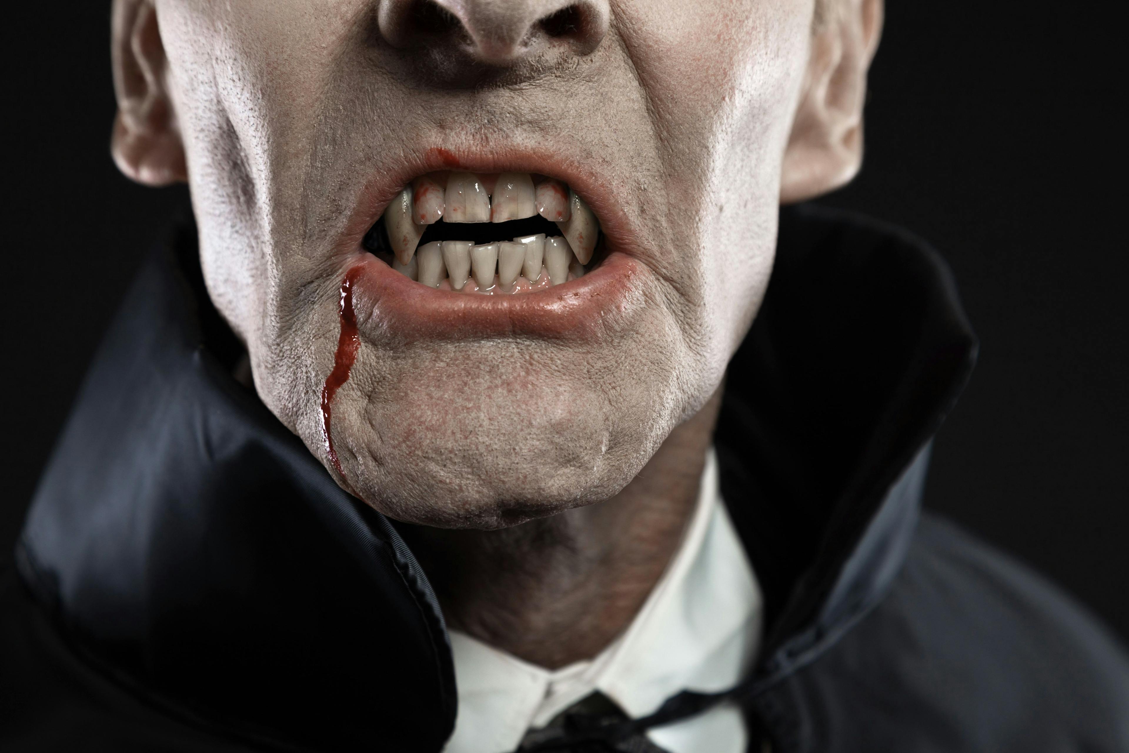 Close-up of dracula with black cape showing his scary teeth. Vam | Image Credit: © ysbrandcosijn - stock.adobe.com