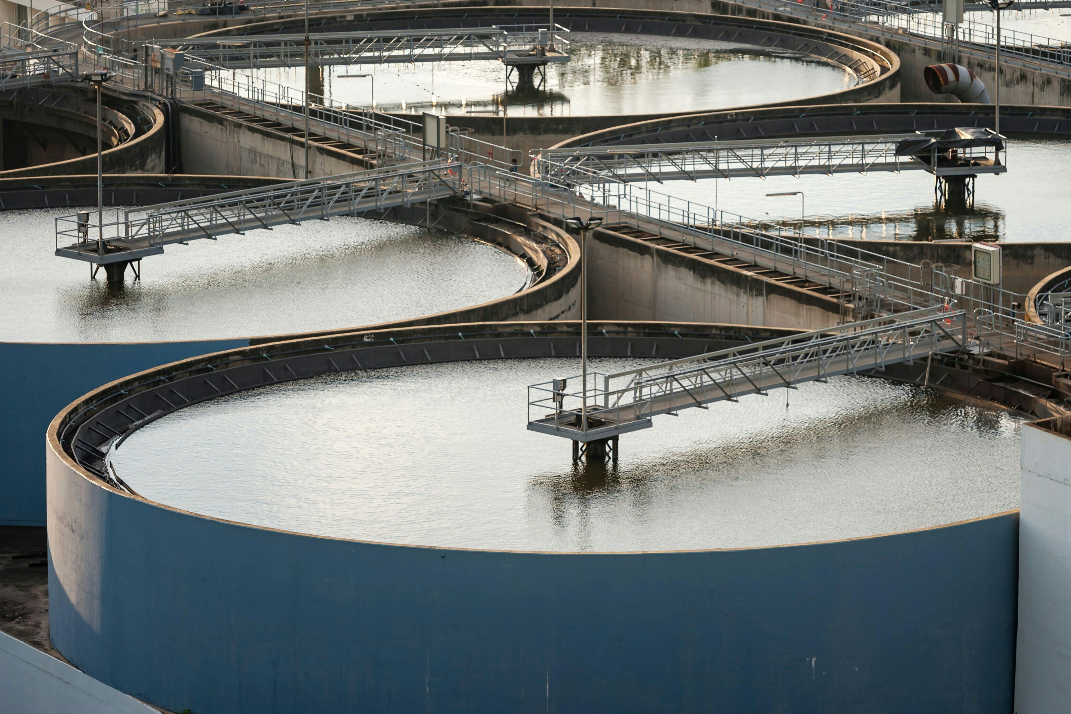 Modern urban wastewater treatment plant. Water purification is the process of removing undesirable chemicals, suspended solids and gases from contaminated water. Water cleaning facility outdoors. | Image Credit: © arhendrix - stock.adobe.com