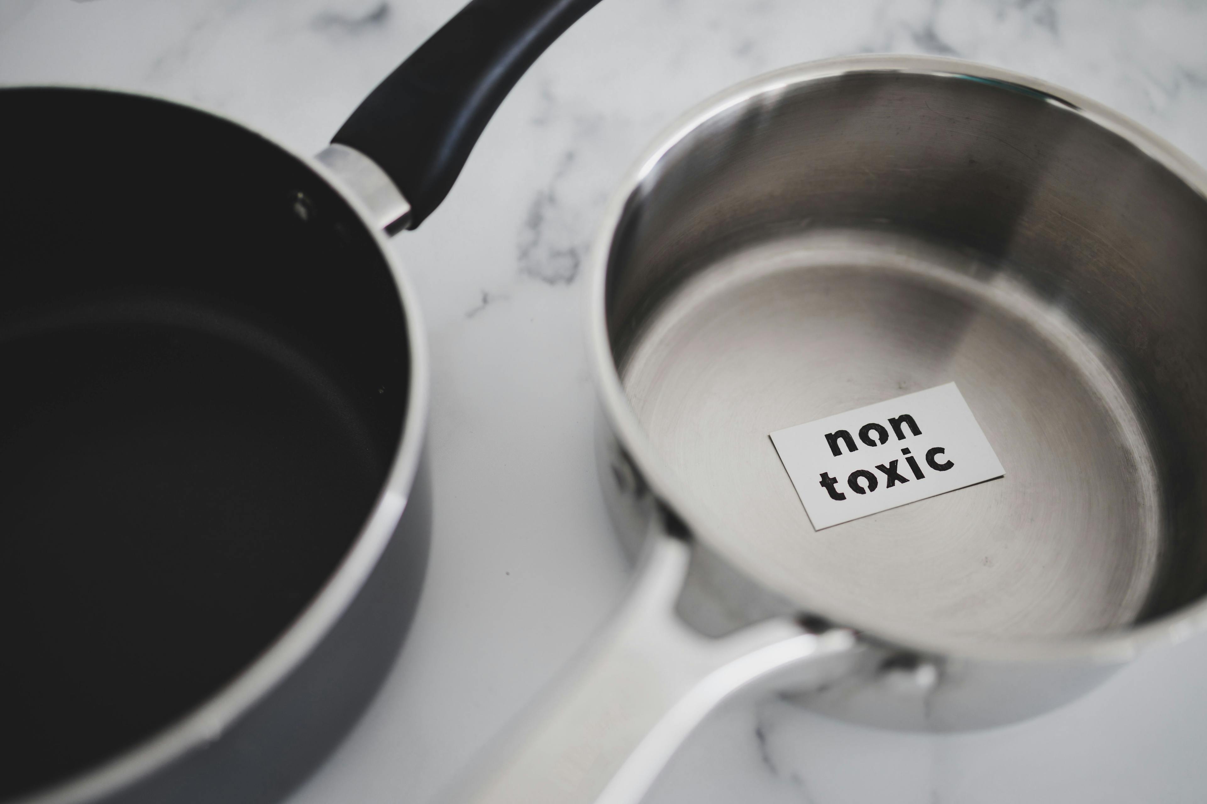 healthy cooking concept, stainless steel vs non stick saucepan side by side with Non Toxic label on the first one | Image Credit: © faithie - stock.adobe.com