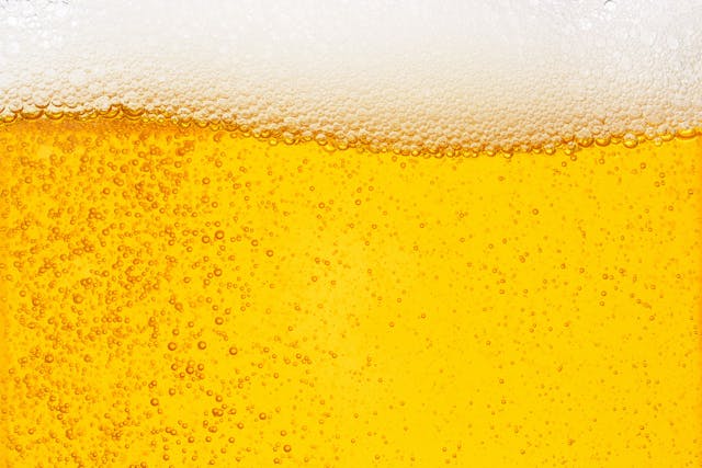 Pouring beer with bubble froth in glass for background on front view wave curve shape | Image Credit: © Love the wind - stock.adobe.com