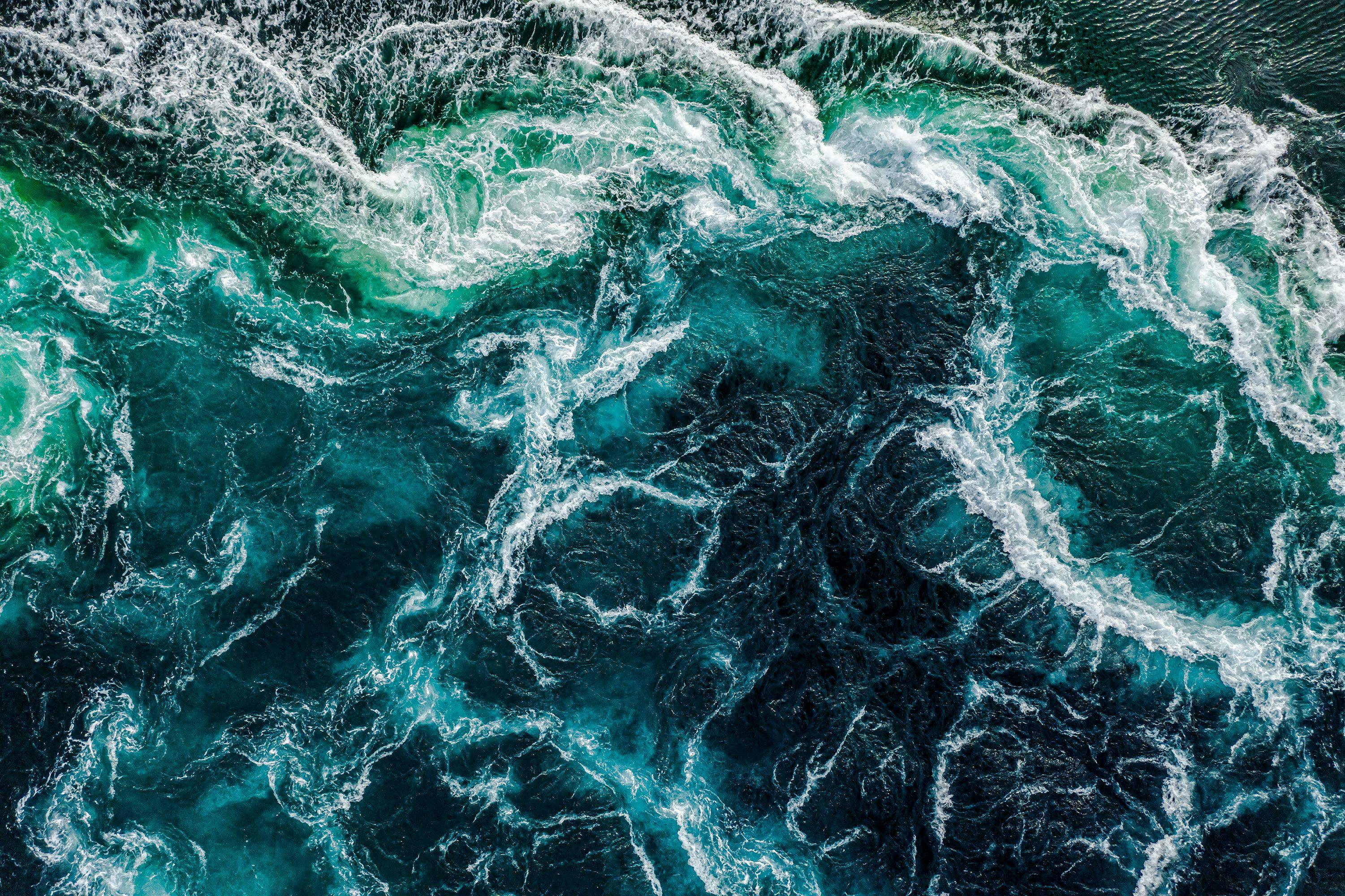 Waves of water of the river and the sea meet each other during high tide and low tide. Whirlpools of the maelstrom of Saltstraumen, Nordland.