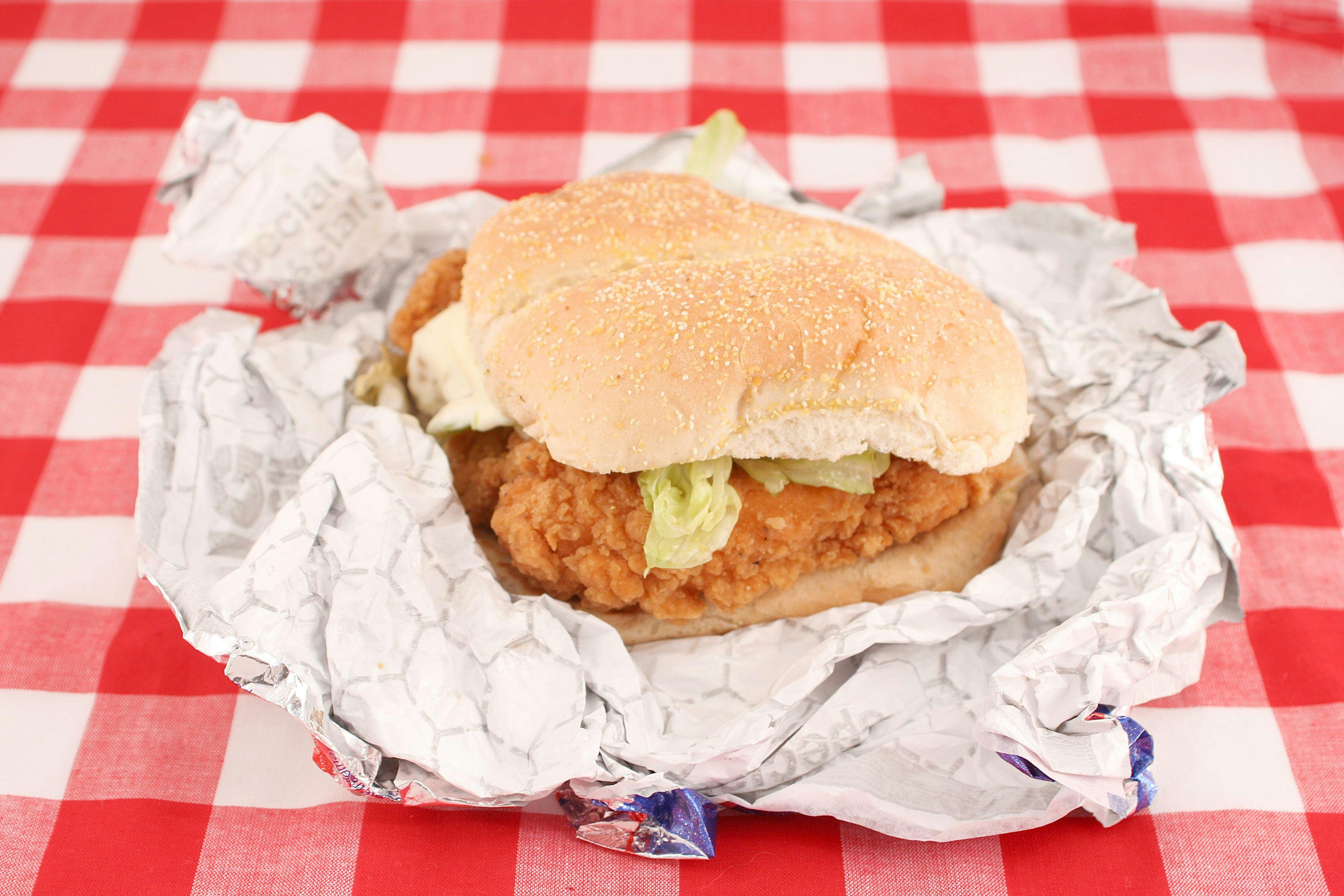 fast food crispy chicken burger still in wrapper | Image Credit: © GVictoria - stock.adobe.com