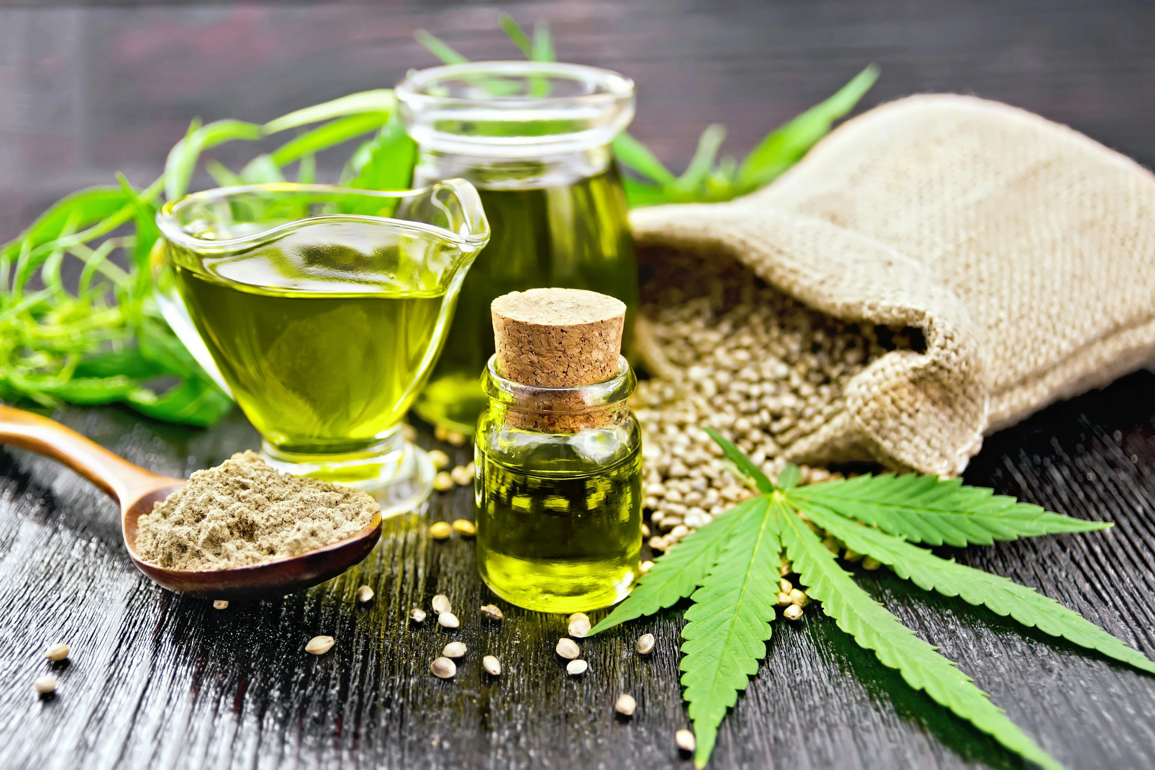 Oil hemp in two jars and sauceboat on wooden board | Image Credit: © kostrez - stock.adobe.com