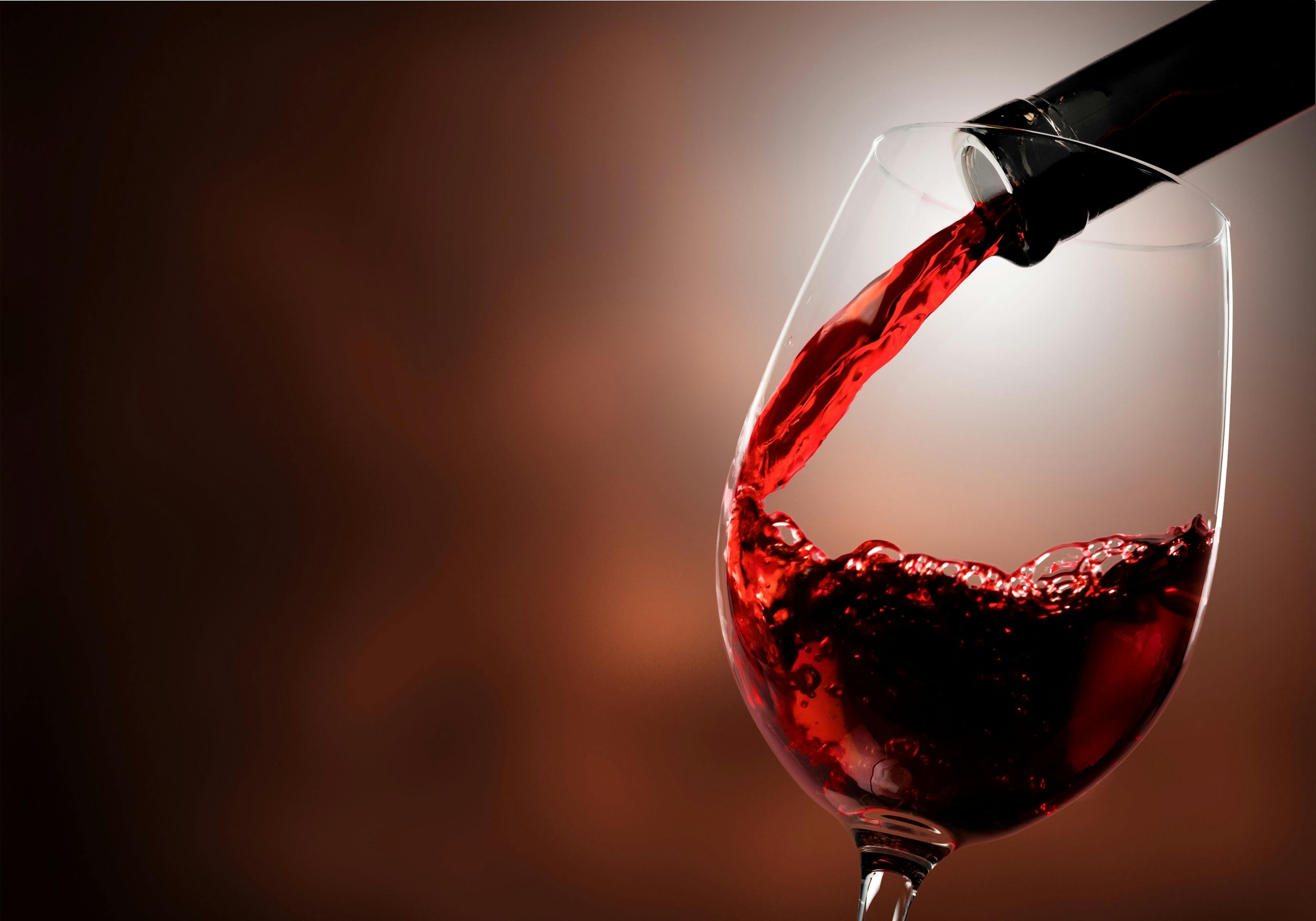 Red wine pouring in glass on background | Image Credit: © BillionPhotos.com - stock.adobe.com