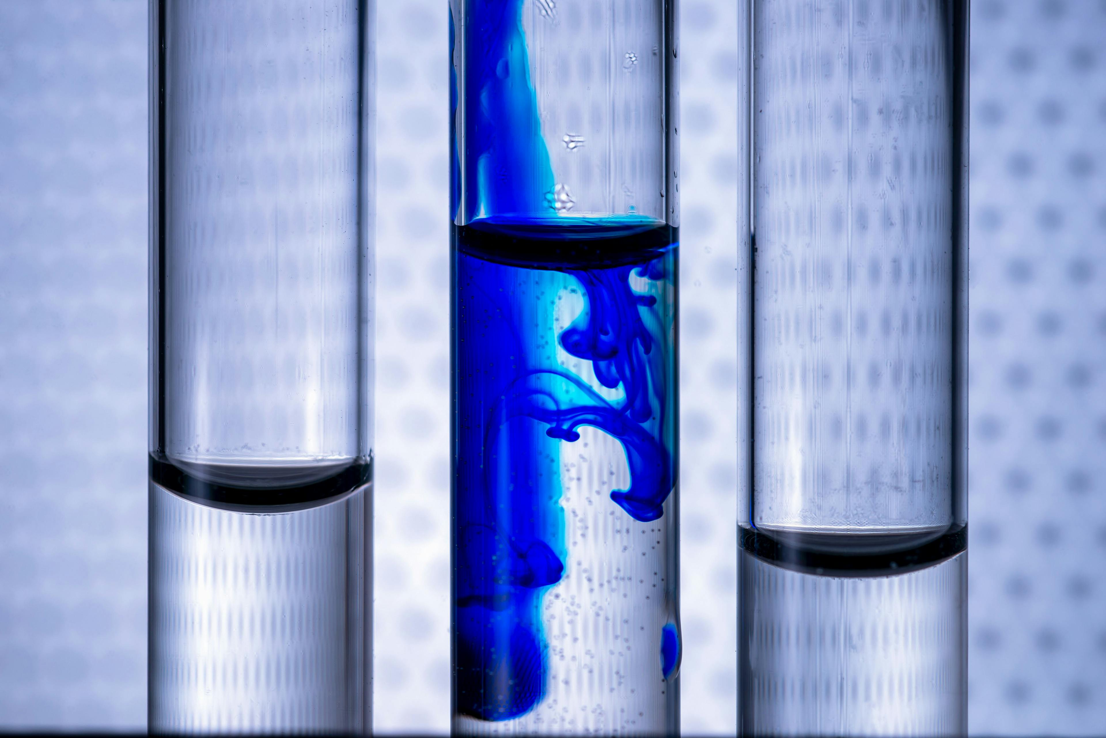 Closeup liquid of blue color ink in water in a test tube of vitro. Concept idea on a medical theme. | Image Credit: © Ivan Uralsky - stock.adobe.com