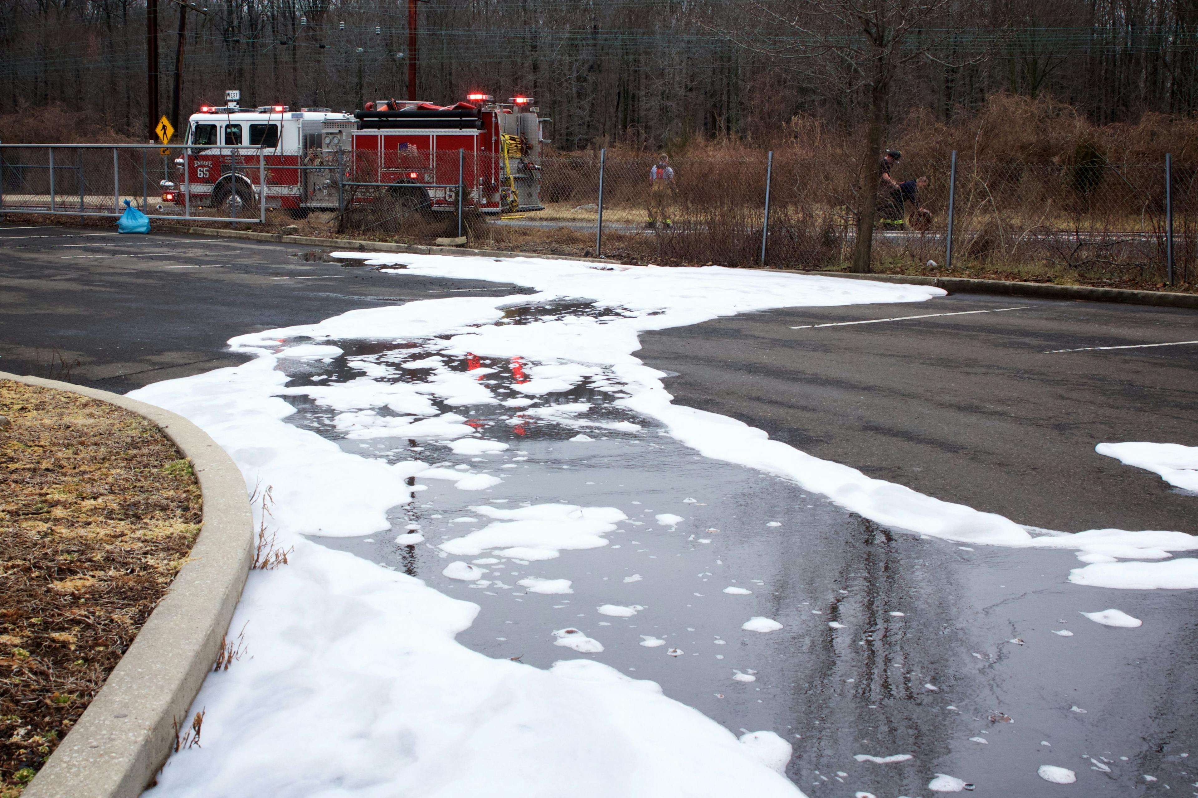 Firefighting foam remains on the ground surface following a tanker truck accident. | Image Credit: © Jana