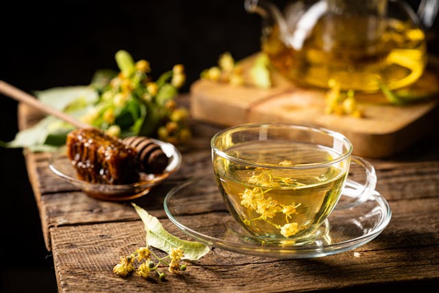 Cup of herbal tea with linden flowers on dark background | Image Credit: © petrrgoskov - stock.adobe.com.