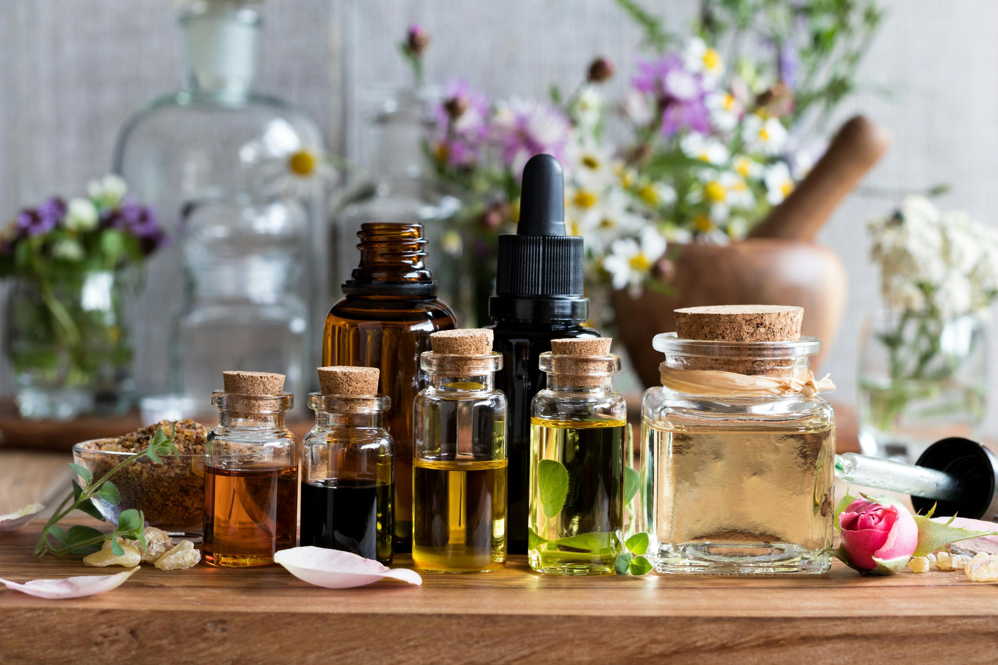 Selection of essential oils with herbs and flowers | Image Credit: © Madeleine Steinbach - stock.adobe.com