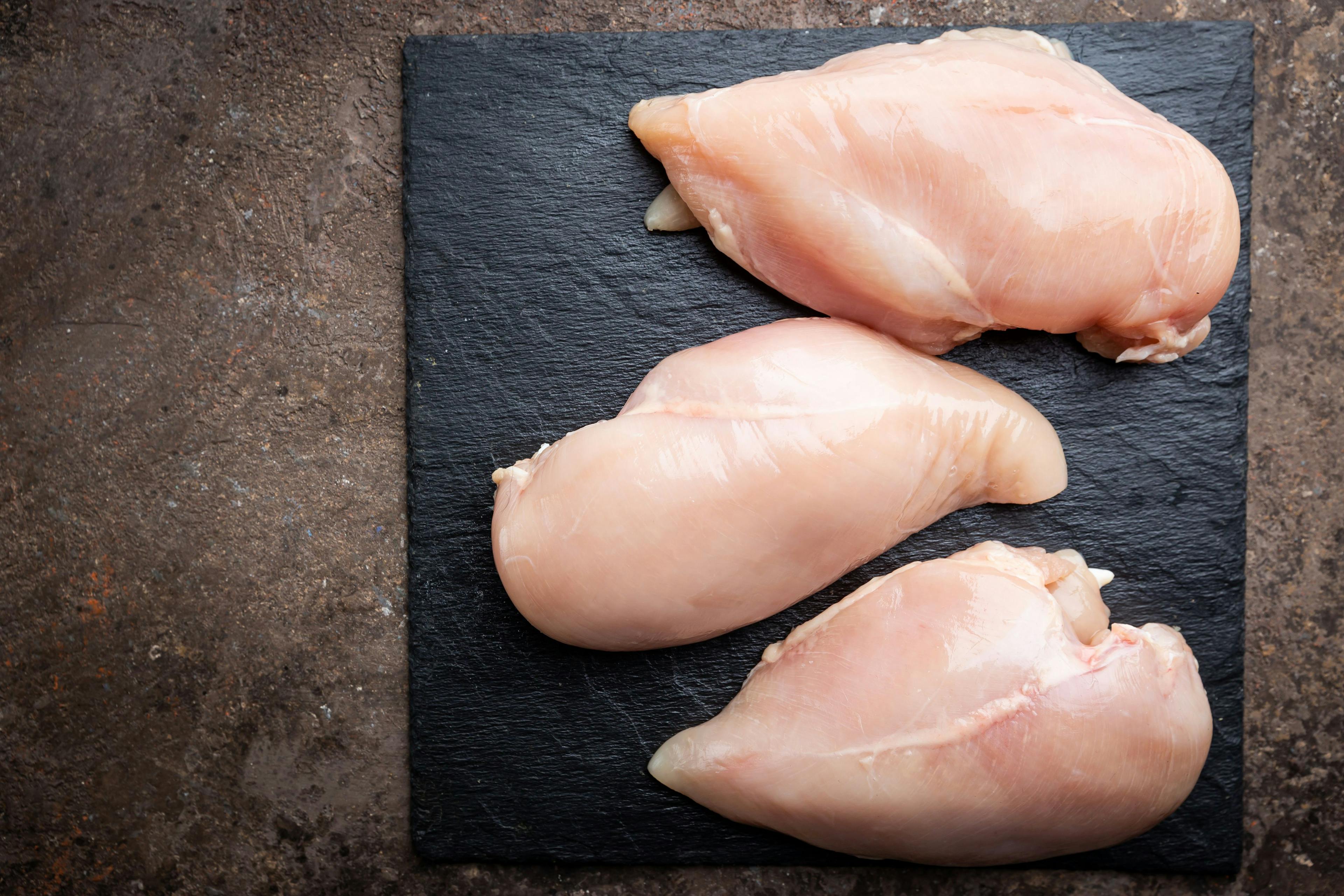 Fresh raw chicken breast, top view. Culinary cooking ingredients | Image Credit: © petrrgoskov - stock.adobe.com