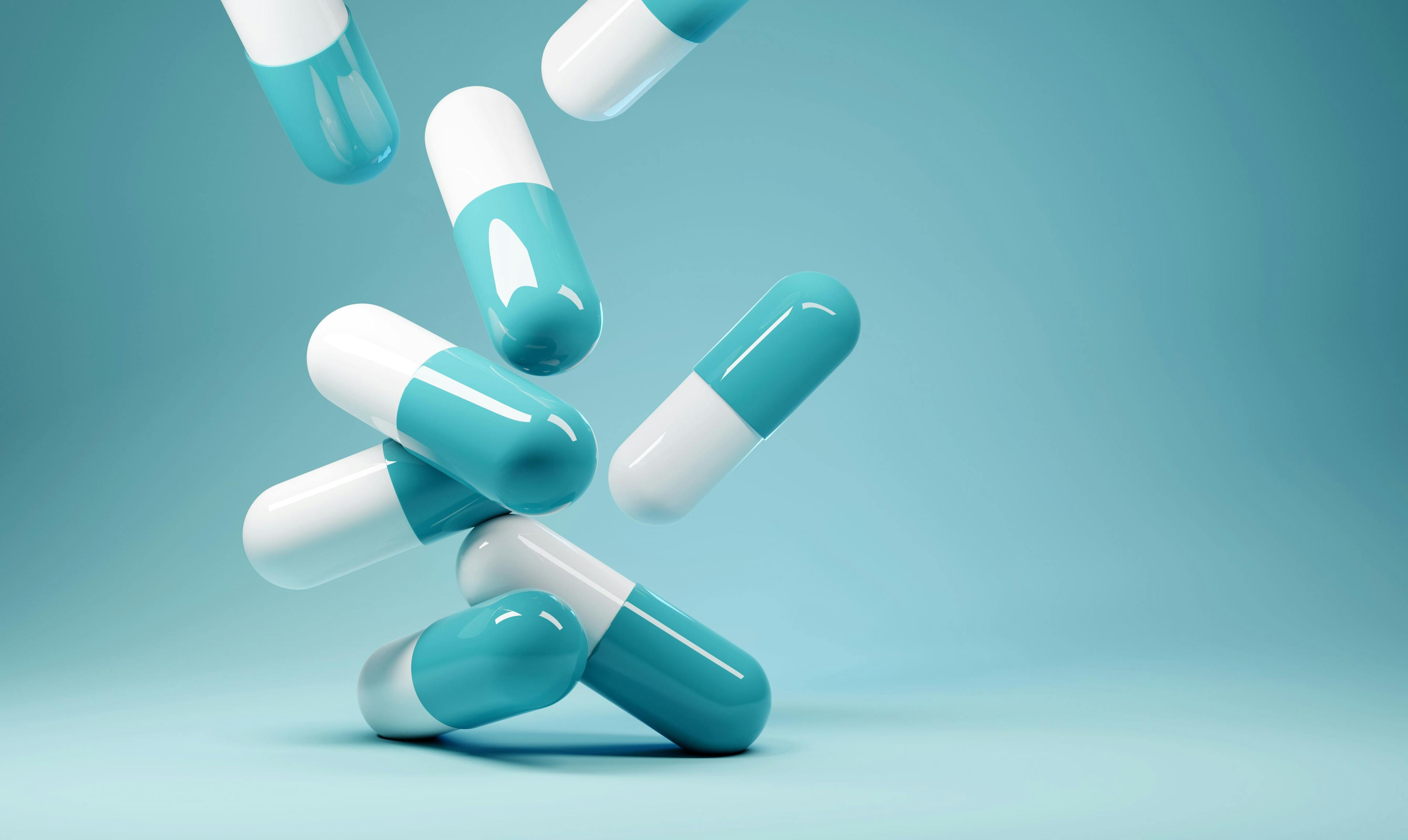 A group of antibiotic pill capsules falling. Healthcare and medical 3D illustration background. | Image Credit: © James Thew - stock.adobe.com