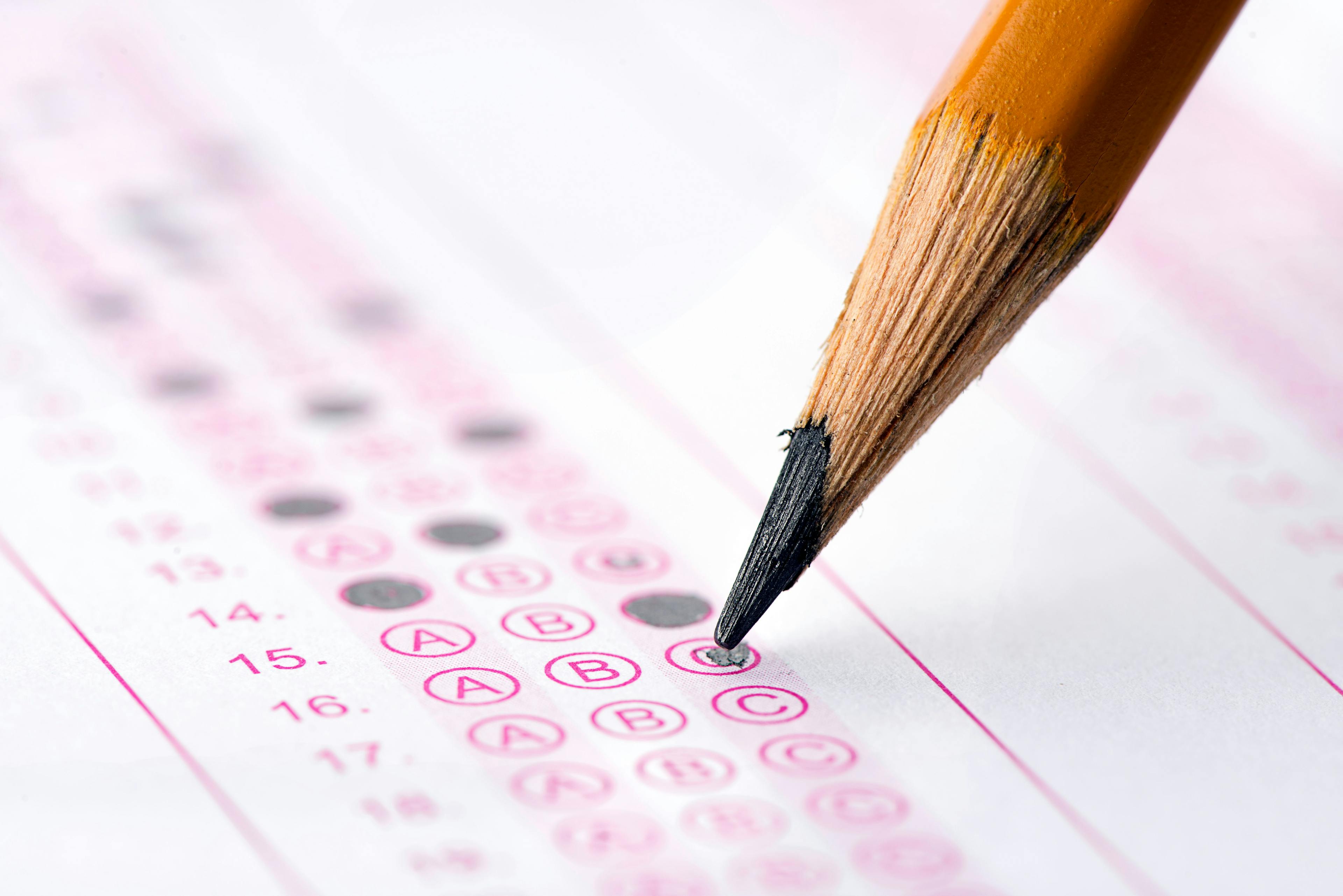 pencil filling out a Scantron answer sheet, a visualization of test taking