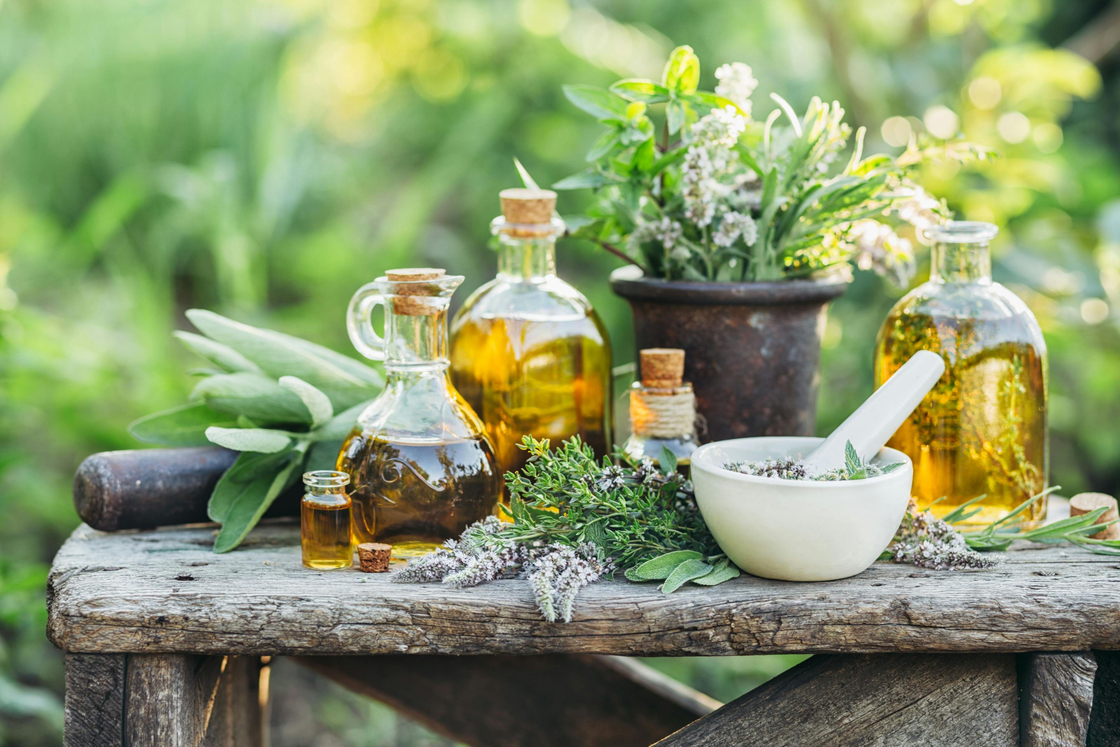 Fresh herbs from the garden and the different types of oils for massage and aromatherapy. | Image Credit: © valya82 - stock.adobe.com