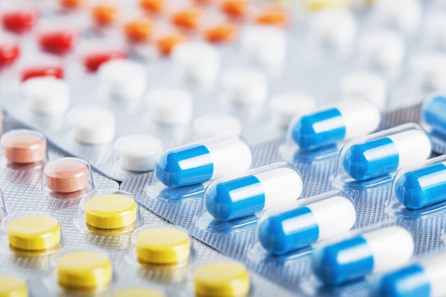Heap of medical pills in white, blue and other colors. Pills in plastic package. Concept of healthcare and medicine. | Image Credit: © okskaz - stock.adobe.com
